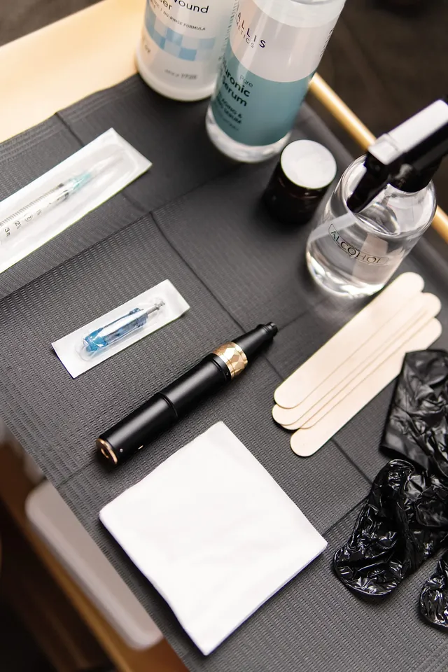 Sanitized microneedling tools and cartridges laid out before a session